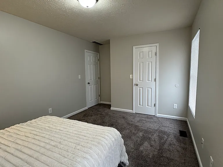 (3-Bedroom 1.5 Bath Unit) Front Bedroom - Freshly painted and updated carpet.