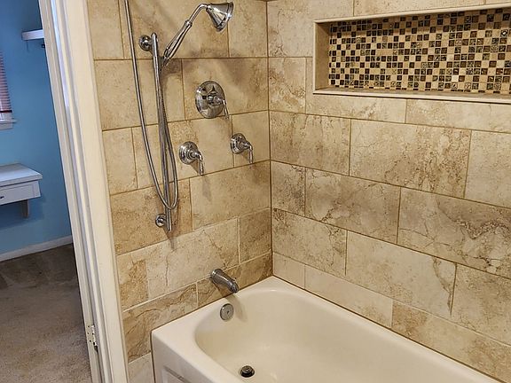 Updated Bathrooms with dual shower heads made by Kohler! Very handy when cleaning the surround tub!