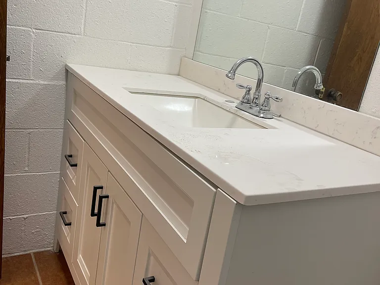 Private bathroom of bedroom 2. All brand new counter, sink, faucet, mirror, floor tile and painted.