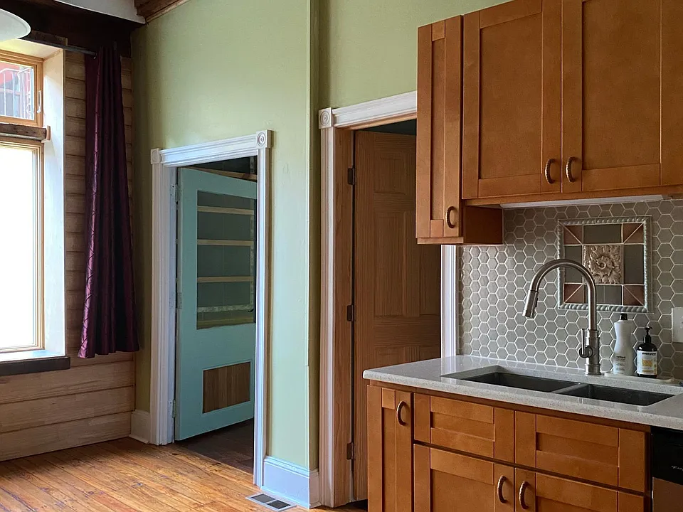 Kitchen, bathroom door, and door to bedroom 2.