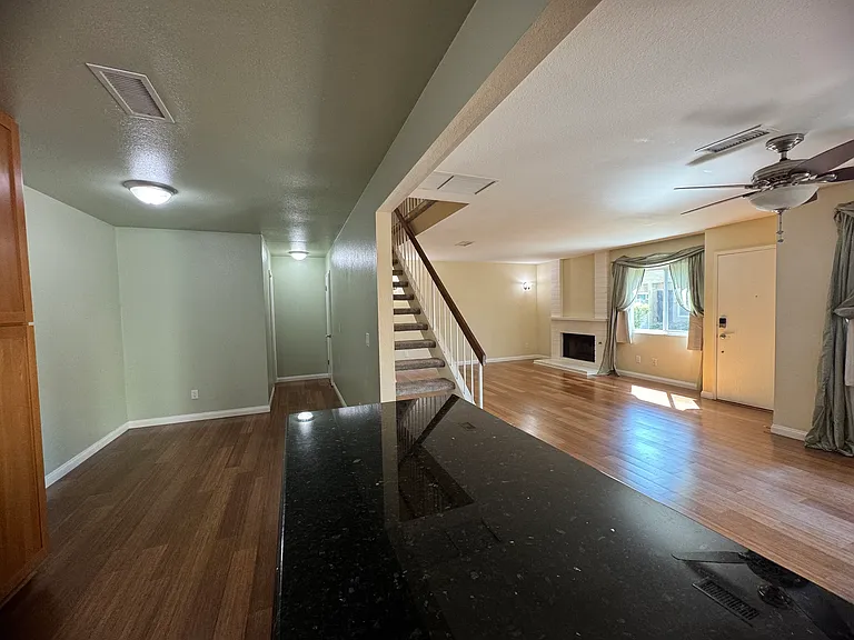 Bright, open-concept living area with premium flooring and seamless flow into the kitchen