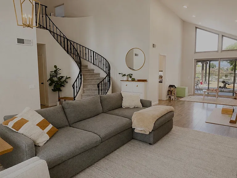 Dramatic vaulted ceilings and a sweeping curved staircase create a grand first impression in this spacious executive home.