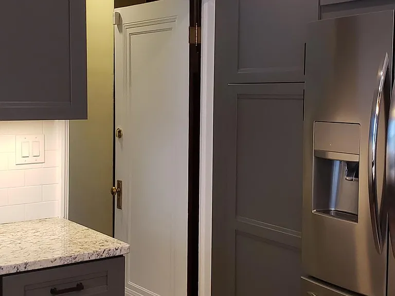 Kitchen looking into back hallway that leads to the basement.