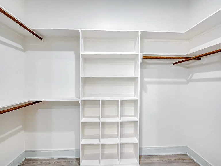 Large walk-in closets with custom built-in shelving