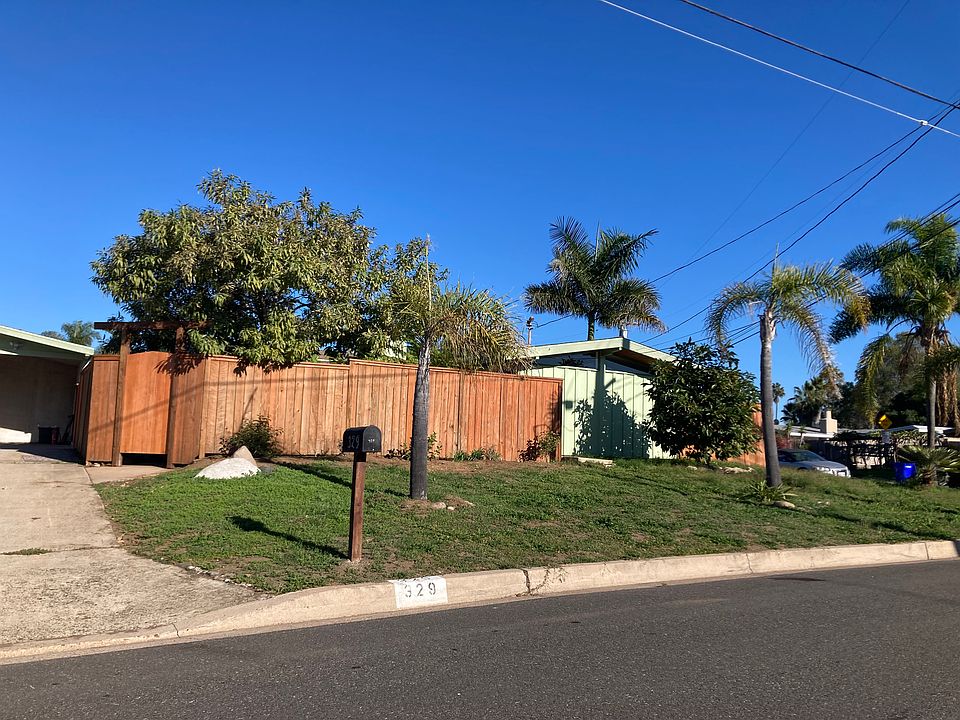 Street view of driveway, front patio fence, west wall of master bedroom
