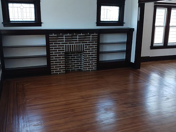 Living room with refinished hardwood floor. New ceiling fan.