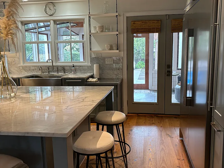 Kitchen opens to a four season porch and to the right is a very large walk in pantry