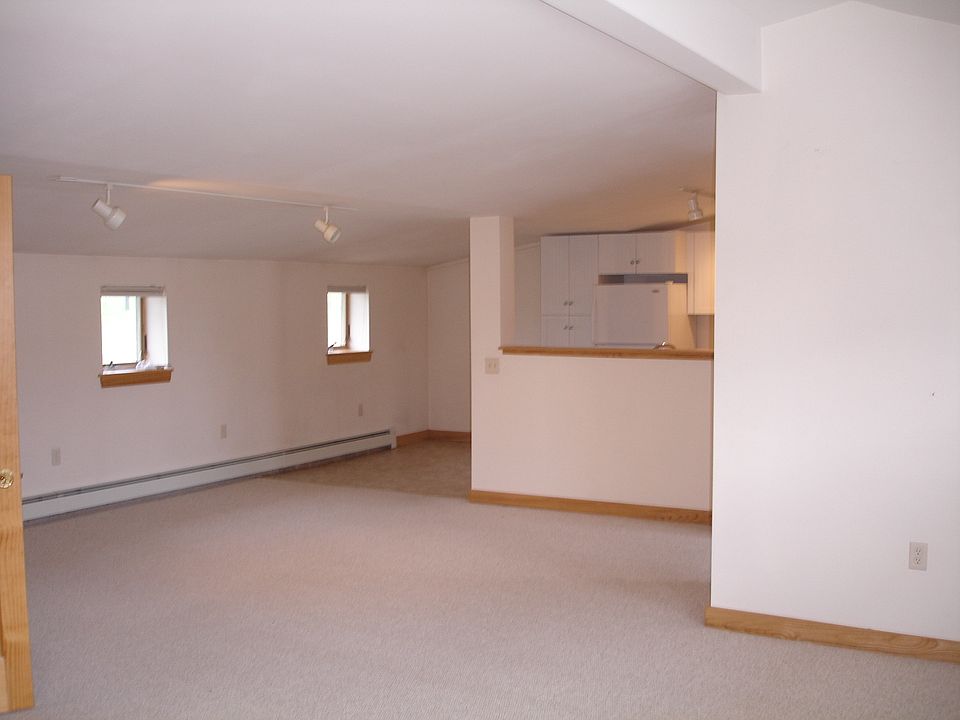 View of the dining area from the living area. Kitchen behind the wood covered divider.