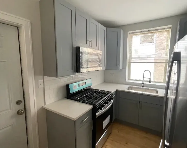Formal Kitchen with Hardwood floors and Stainless steel appliances.