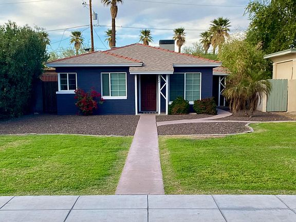 Front of the duplex house. The entry to this unit is around the right side, giving it privacy from the street.