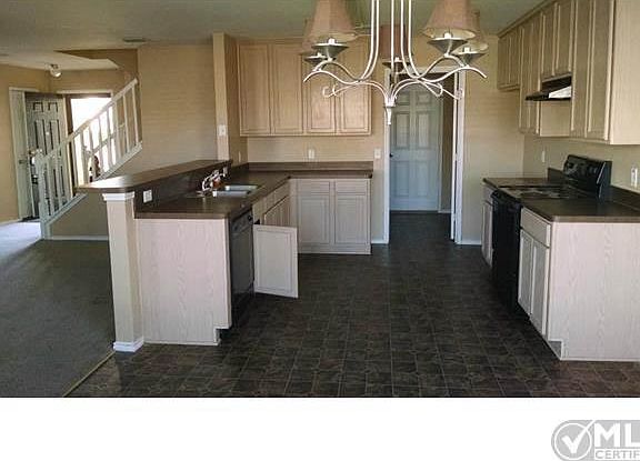 standing in Dining area looking into Kitchen and downstairs