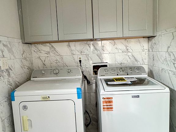 Laundry room with new washer and drier.