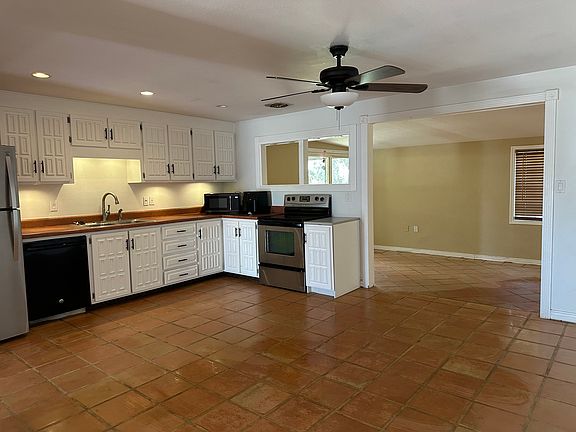 Kitchen and sunroom. Door to garage in kitchen.