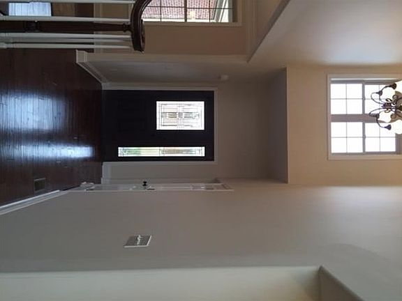 The entry way with 18 ft ceilings.  To the left is the formal dining room.  To the right is the den.