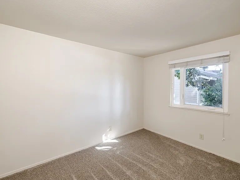 Bedroom C is filled with natural light and offers a peaceful view, ideal for rest or focus.