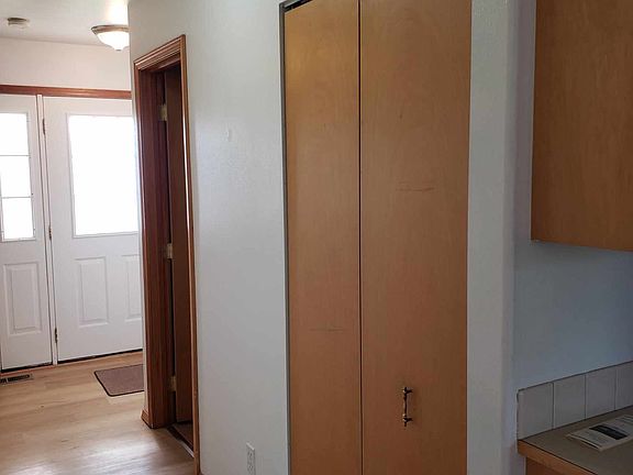 Hall from kitchen to front door. Doors on the side open to closet