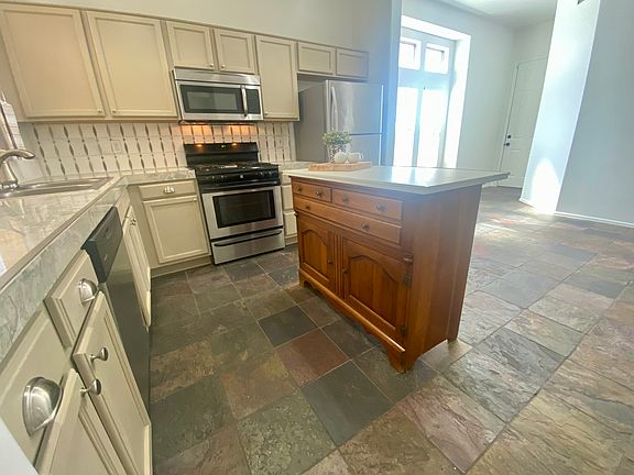 Marble backsplash with stainless appliances