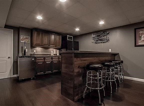 Custom bar with Lots of beautiful cabinets in the lower level.