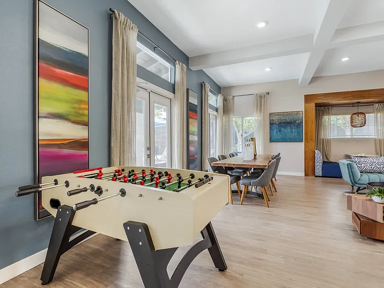 The clubhouse features a foosball table, adding a fun and interactive element for residents to enjoy during their downtime or while hanging out with friends and neighbors.