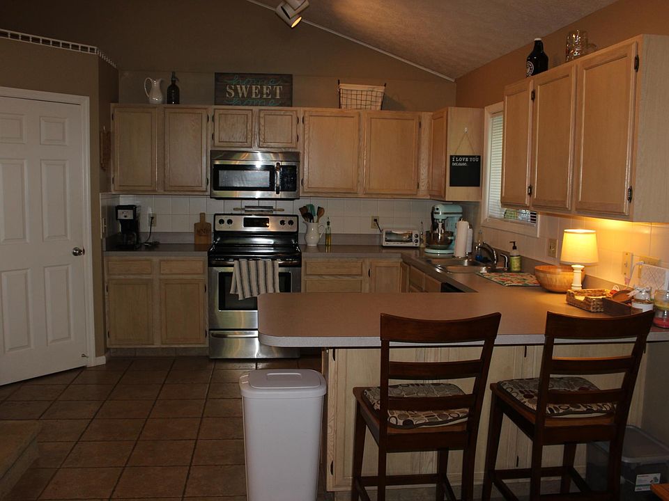 Kitchen with tile floors, stainless steel appliances