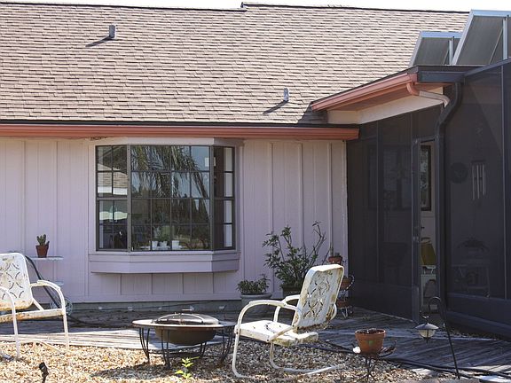backyard firepit area; view of bay window in kitchen