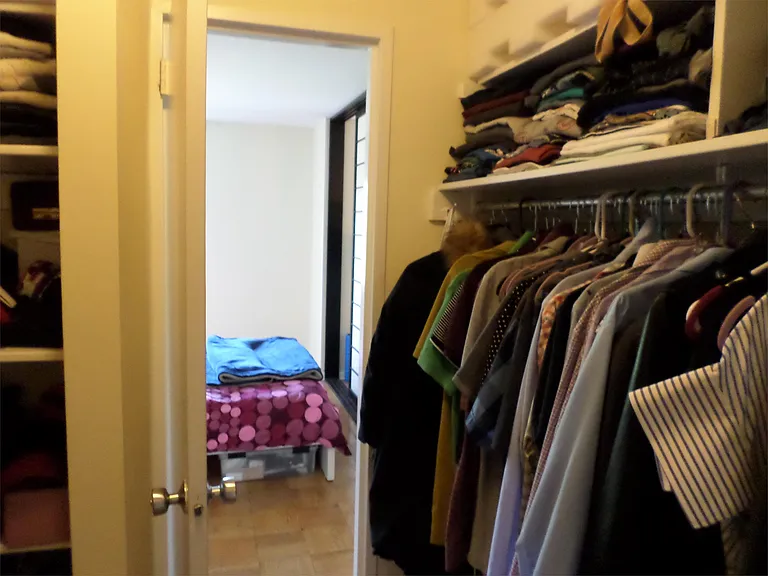 Walk-through closet from bedroom and bathroom