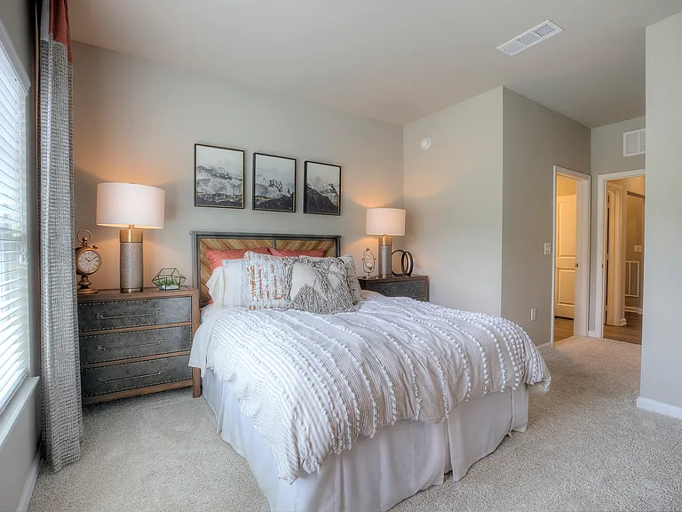 Bedroom with a window and carpeted flooring