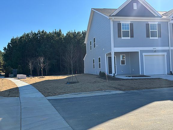 corner townhome with wood backside and privacy