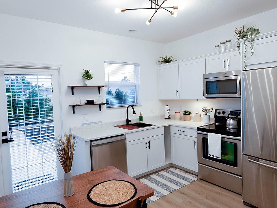 The fully stocked kitchen has wonderful views of the back yard and comes with stainless steel appliances and plenty of storage space.