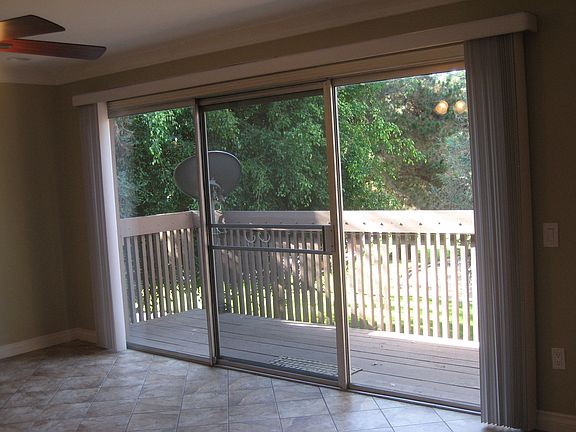 View of balcony and trees from living room