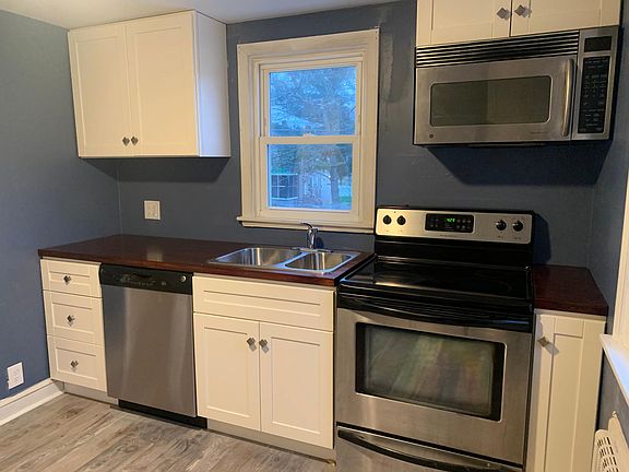 Kitchen with microwave, dishwasher, and full size oven.
