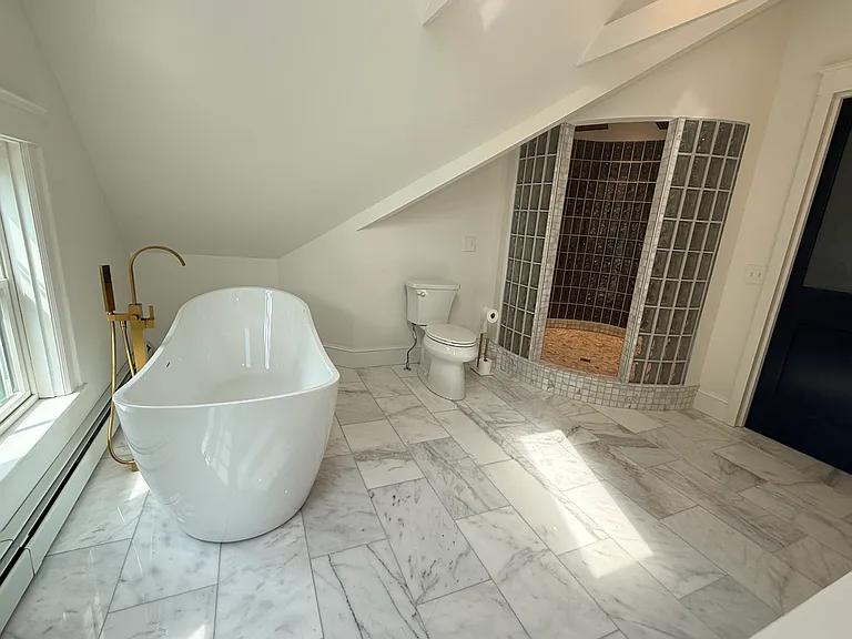 3rd floor primary spa bathroom with soaker tub and huge circular shower with double showerheads