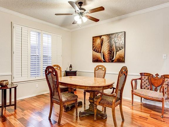 Wood floors in living and dining rooms. Plantation shutters. Crown moldings and chair rail.