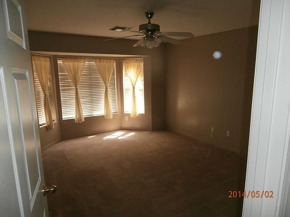 Master bedroom with bay window. Carpet replaced with wood-like tile planking