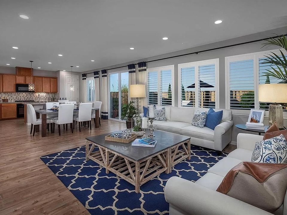 Spacious and bright family/dining/kitchen with plantation shutters and lovely landscaped patio/yard.