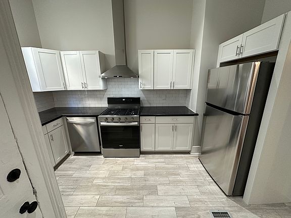Fully renovated kitchen with granite countertops and all-new stainless steel appliances