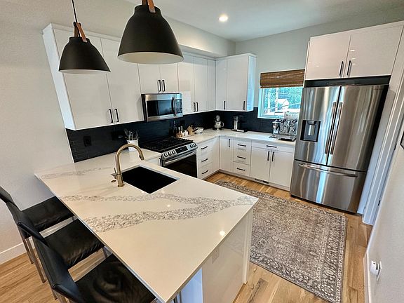 Modern kitchen with stainless steel appliances and gas range