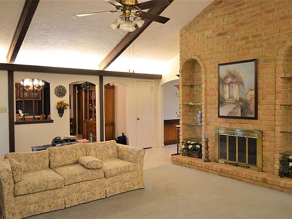 The home has been lovingly maintained by the original owners and features this beautiful gas fireplace with floor to ceiling brick and built-in shelving.