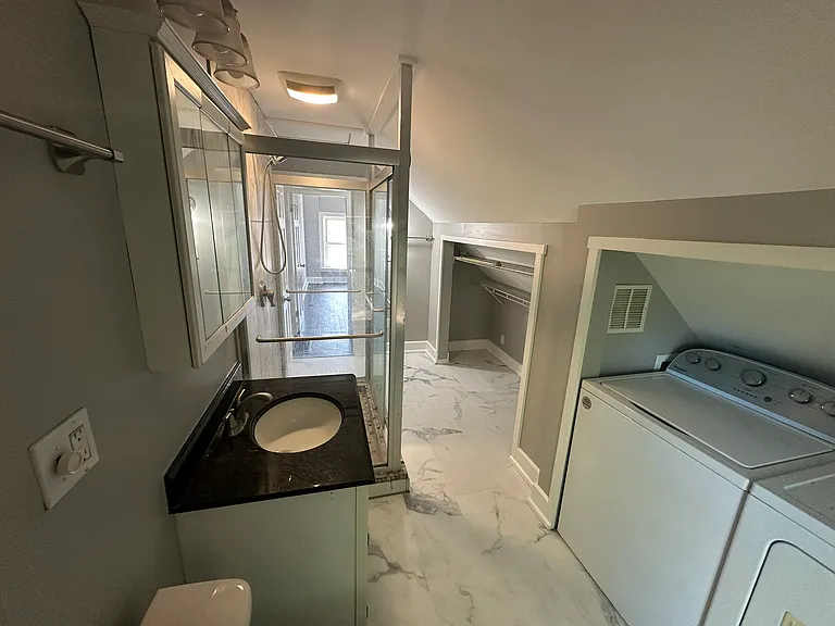 Bathroom with standup shower, washer, dryer, closet