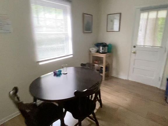 Dining room between living room and kitchen. Back door opens to small yard.