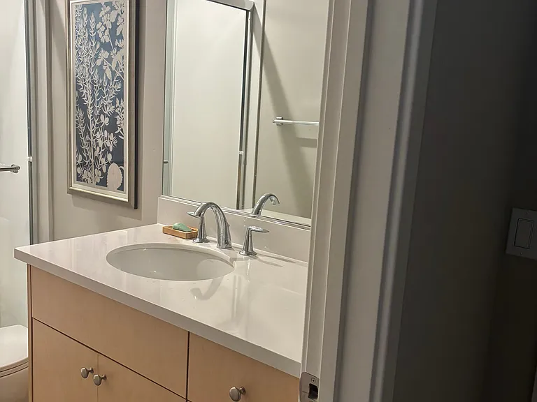 1st Floor full bath with stand in shower that is connected to bedroom.