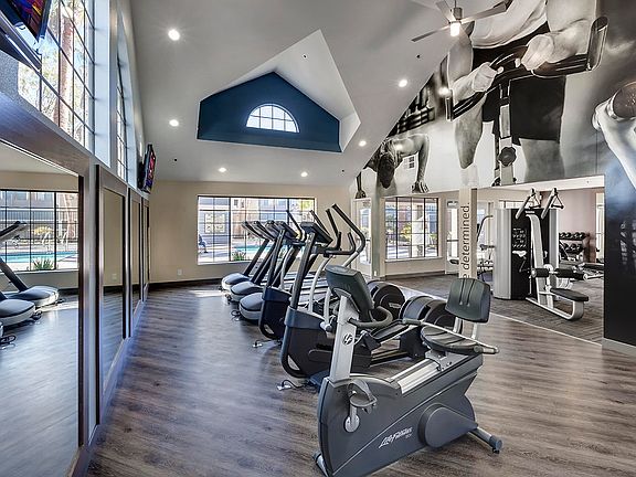 Fitness center with cardio and strength training equipment.