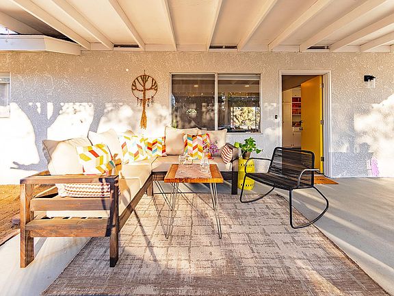 Covered back patio includes custom outdoor sofa.