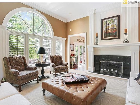 Formal Living Room looking out to paver patio & lush landscaping