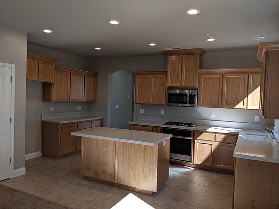 Lovely kitchen large island and quartz countertops.