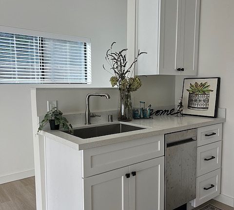 Beautiful new kitchen with white shaker cabinetry, white quartz counter tops, stainless steel appliances.