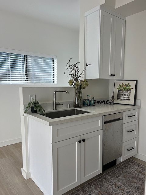 Beautiful new kitchen with white shaker cabinetry, white quartz counter tops, stainless steel appliances.