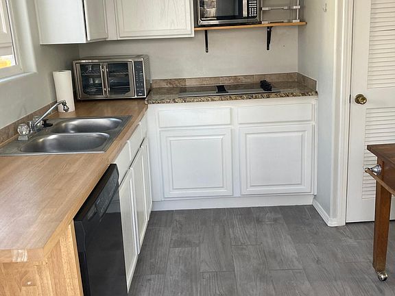 Kitchen with microwave, dishwasher, cooktop and eating area