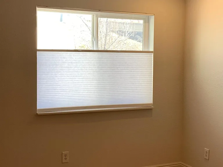 Living space with new blinds and can lighting