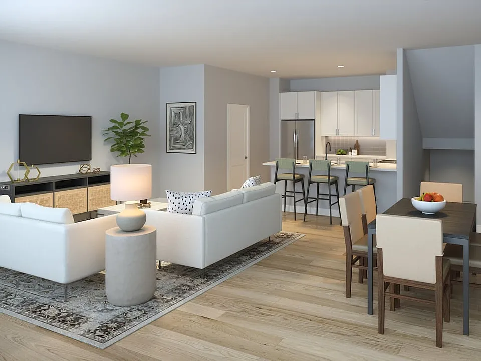Townhomes featuring stainless steel appliances and seamless open concept kitchen, dining, and living spaces for modern living (Rendering)